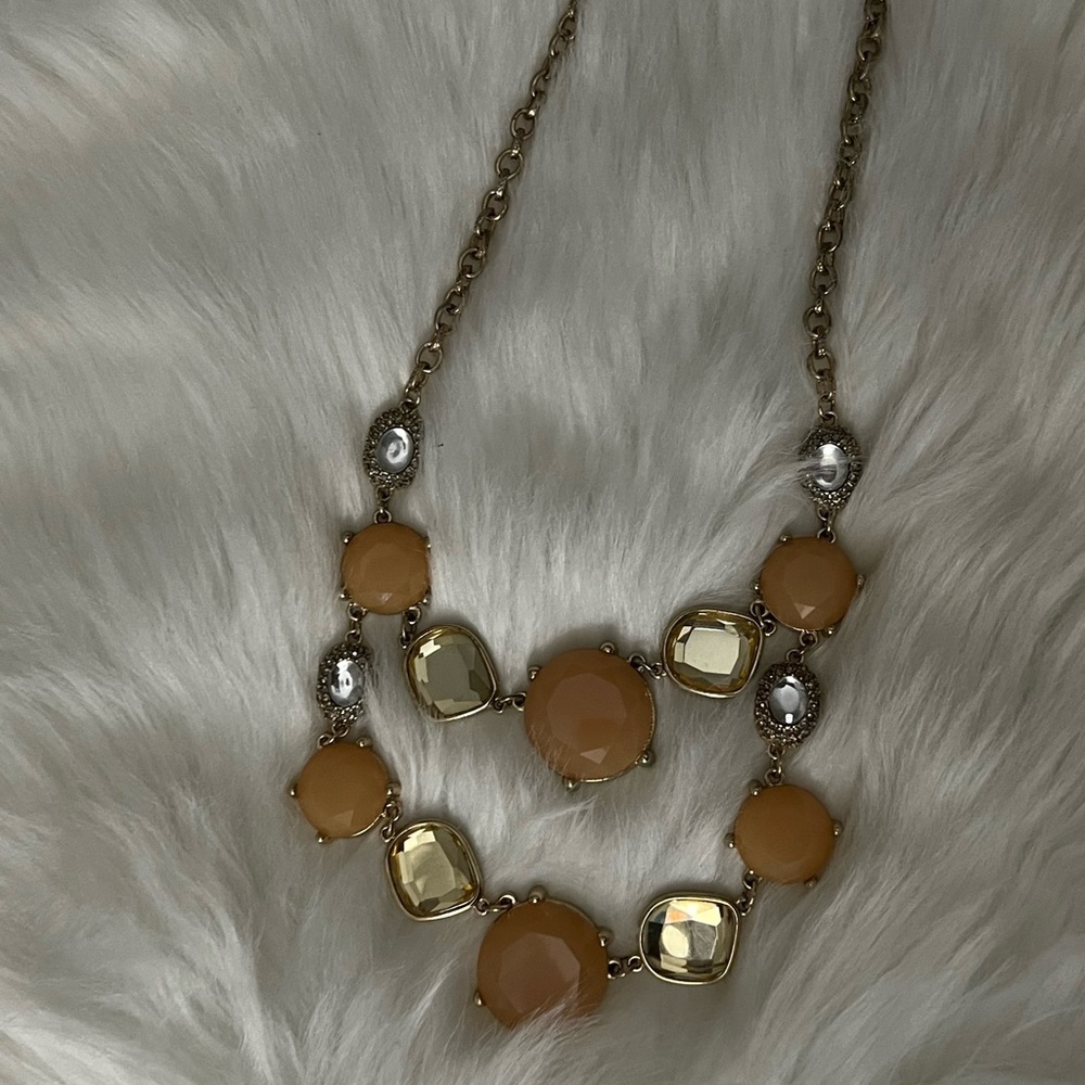 Tiered Gemstone Necklace features gold tone chain and stones